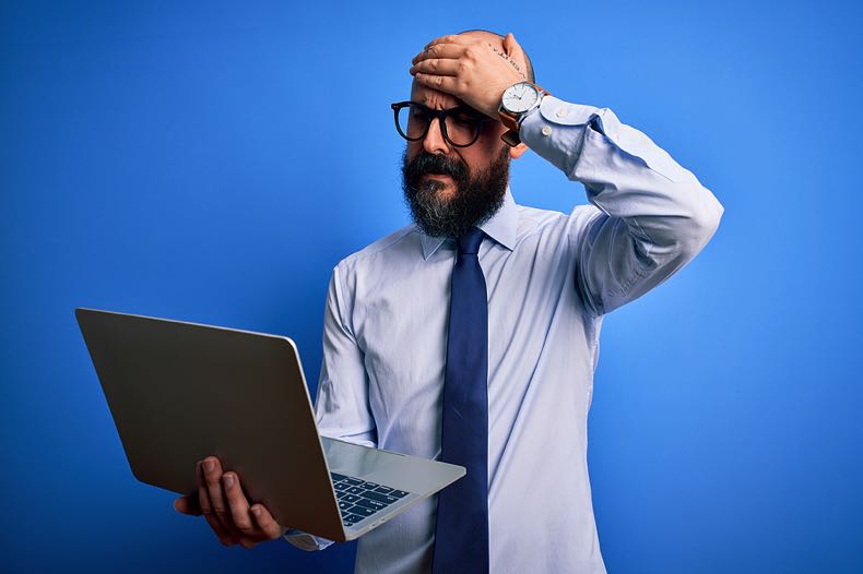 Man with computer looking confused