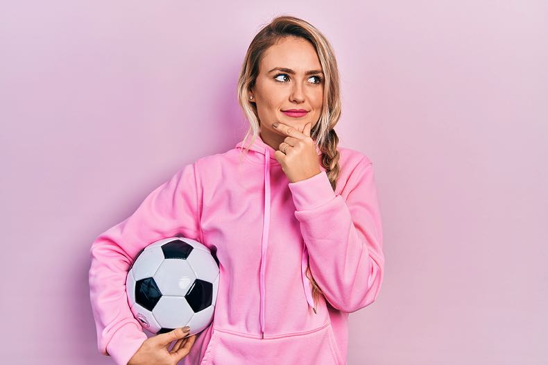 Woman thinking with football
